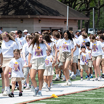 A large group of people walking. Links to What to Give