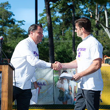 Two men shaking hands. Links to Gifts That Pay You Income